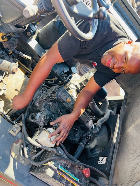 ARAT FARM technician servicing a forklift engine